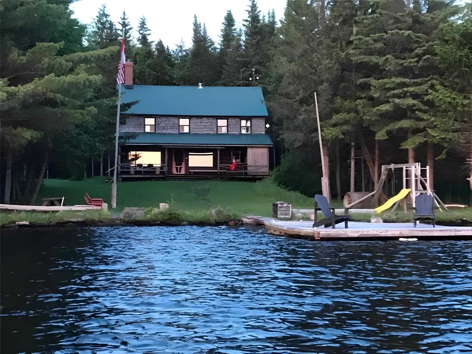 Chalet centenaire en bois rond sur un lac privé.
