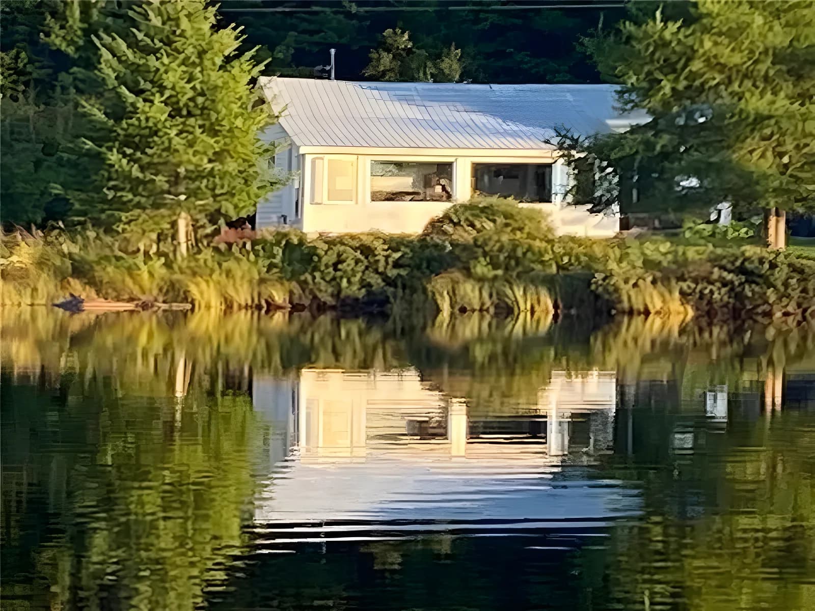 Small cabin on the shore of a quiet natural lake stocked with trout